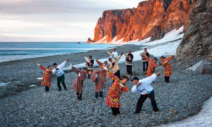 Yupik men and women dancing while wearing their traditional attire